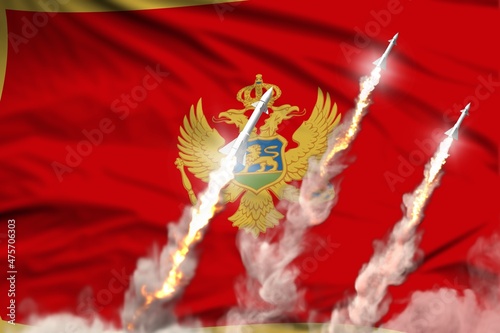 Montenegro ballistic warhead launch - modern strategic nuclear rocket weapons concept on flag fabric background, military industrial 3D illustration with flag photo