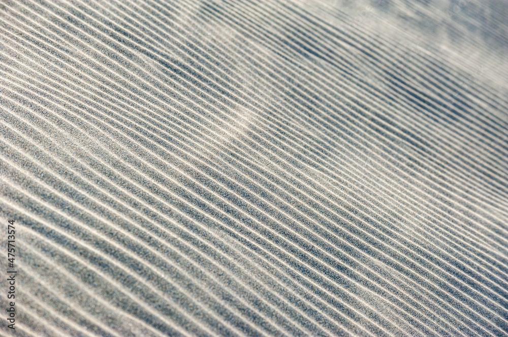 Obraz premium Detail of sand dunes in sand storm. Texture. Background. Canary islands, Maspalomas. Spain. view of the Natural Reserve of Dunes of Maspalomas, in Gran Canaria.