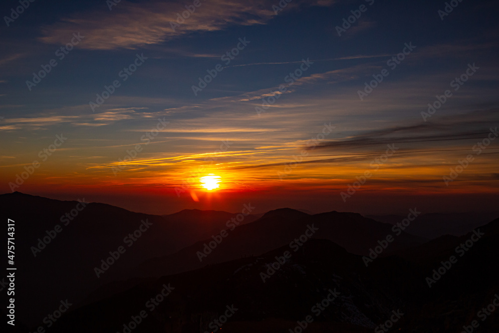 Fantastic views in the mountains during sunset with the silhouette of the peak