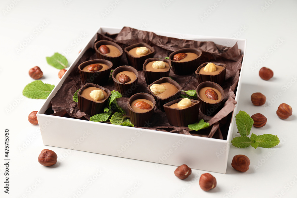 Concept of sweets with chocolate candies on white background Concept of sweets with chocolate candies on white background
