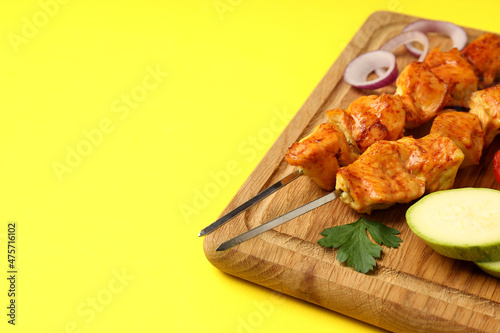 Concept of tasty food with chicken shashlik on yellow background