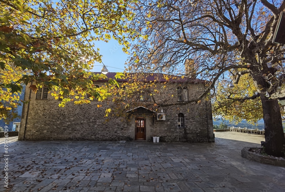 kypseli village central square in autumn season tables chairs plane tree arta perfecture greece kypseli village central square in autumn season tables chairs plane tree arta perfecture greece