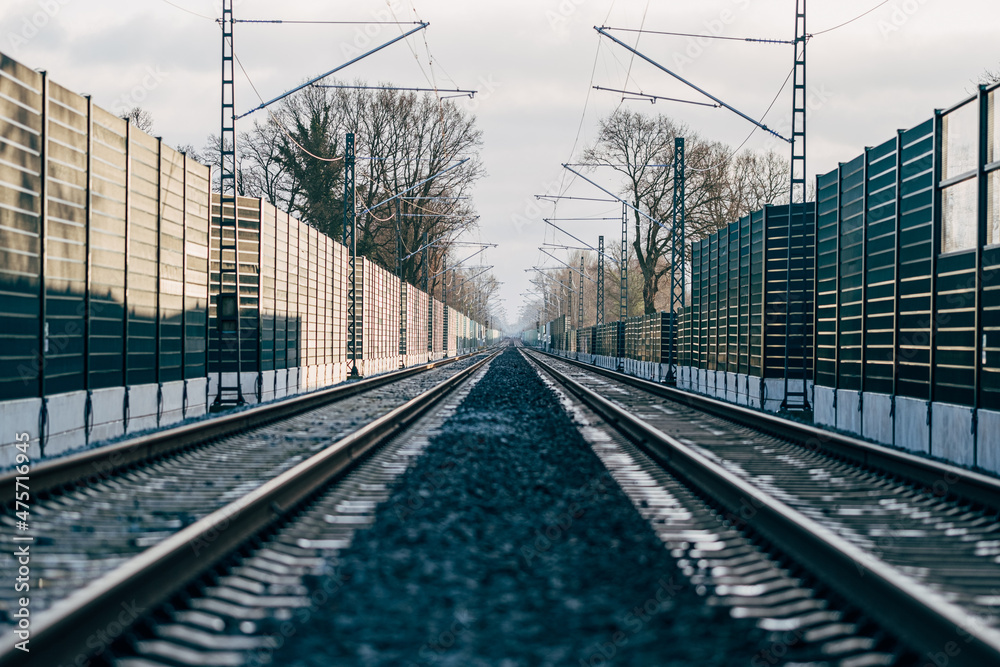 Fototapeta premium Railroad noise barrier. Acoustic wall reducing train sound. Soundproof protection fence along the railway.