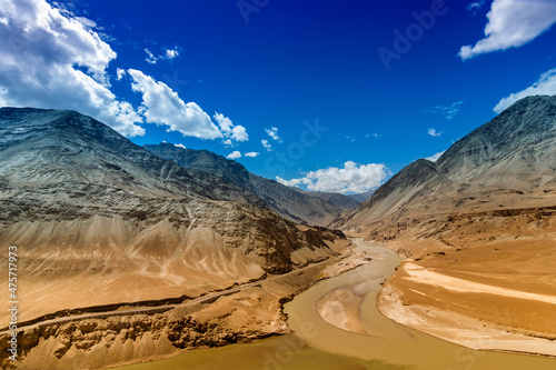 Scenic view of Confluence of Zanskar river from left and Indus rivers from up right - Leh, Ladakh, Jammu and Kashmir, India. Famous tourist spot of Ladakh landscape. Union territory of India. photo