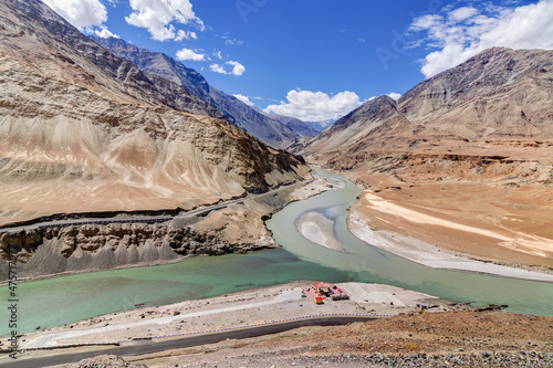 Scenic view of Confluence of Zanskar river from left and Indus rivers from up right - Leh, Ladakh, Jammu and Kashmir, India. Famous tourist spot of Ladakh for all seasons. landscape.