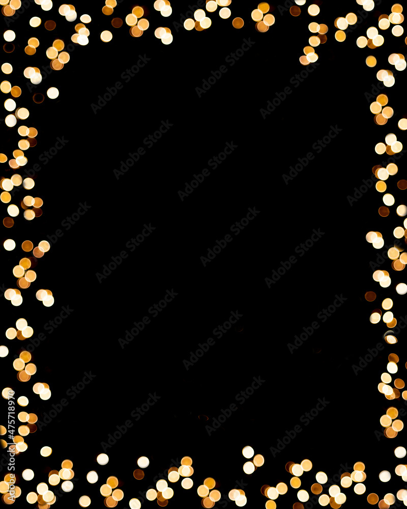 Festive frame made of a golden garland on a black background. Copy Space