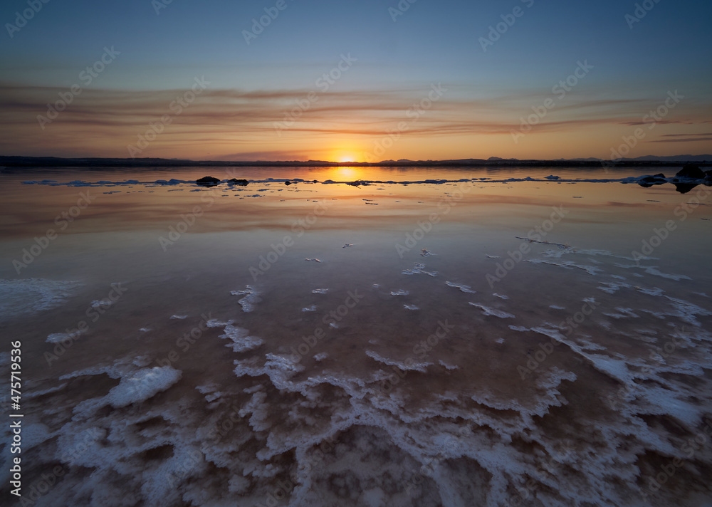 Sunset on the pink lagoon of the salt flats of Torrevieja, Spain