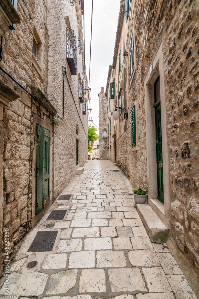 Narrow old town street at Sibenik city, Croatia. Famous tourist destination.