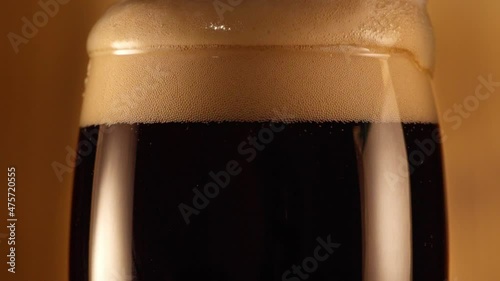 Close up of Glass of Black Beer on Wooden Background