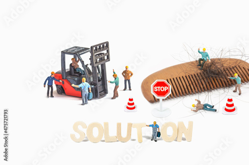 Selective focus of Miniature Worker People  with Wood text on white background.