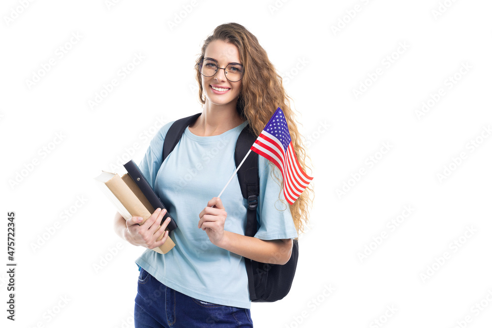 Smiling young student woman with backpack holds books, notebooks and flag USA on white background Smiling young student woman with backpack holds books, notebooks and flag USA on white background