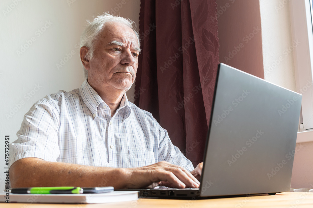 senior old man male sit next at desk, home office online notebook laptop work business distance freelancer senior old man male sit next at desk, home office online notebook laptop work business distance freelancer