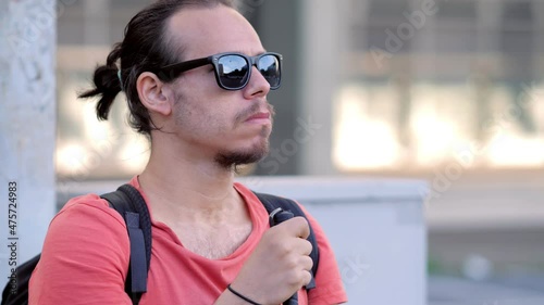 disability, autonomy - young man with a disability on a bench in the city photo