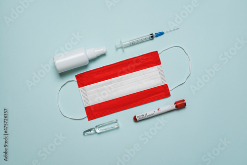 Wallpaper Mural Blood tube for test detection of virus Covid-19 Omicron Variant with positive result, medicine mask with Austria flag superimposed and vaccine.  New Variant of the Covid-19 Omicron Torontodigital.ca