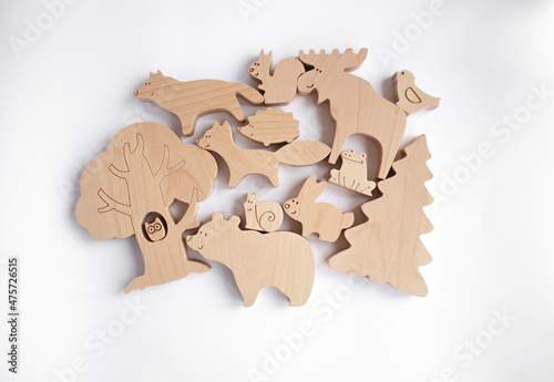 Eco wooden toy farm animals for toddlers on white background.