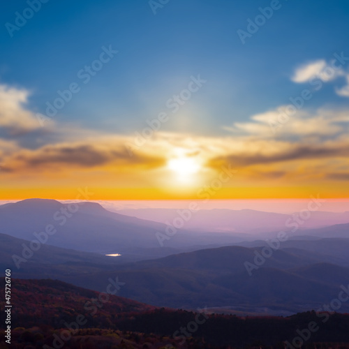winter misty mountain ridge  at the sunset, natural travel background