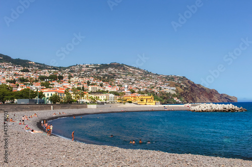 View of sunbathers on the vibrant coastline of Funchal, Madeira, Portugal, from the seafront. photo