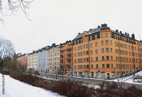 Snowy street of colourful apartment buildings in Östermalm, Stockholm, Sweden.