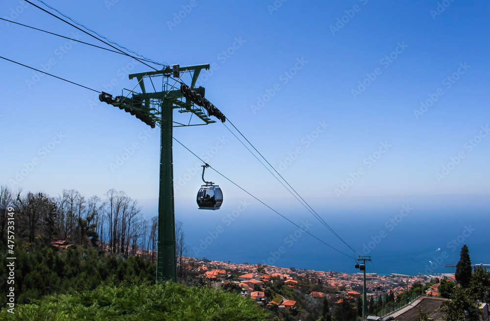 Cable car descending down the scenic mountains of Funchal, Madeira.