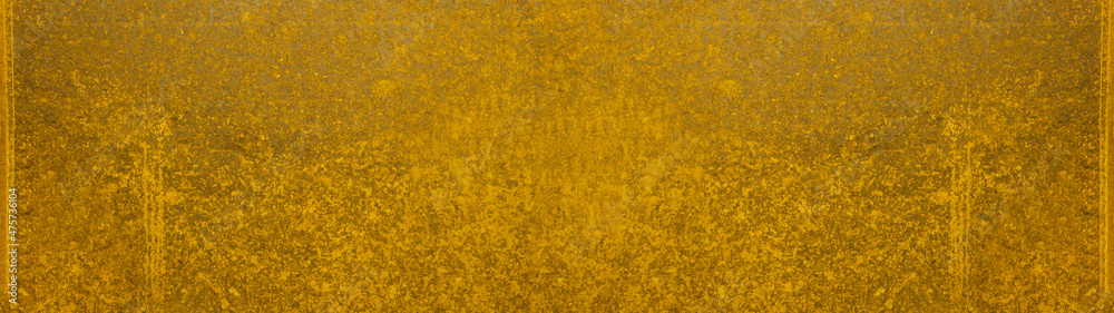 Abstract yellow colored painted stone concrete cement scratched weathered grunge wall or floor texture, background panorama banner long