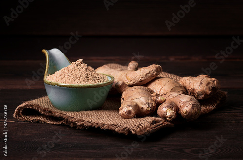 Ground and fresh ginger root, on a wooden table, rustic style, selective focus, no people,