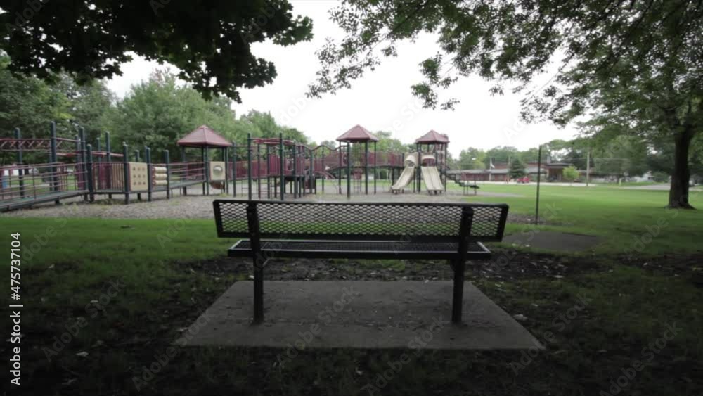 Empty park bench near quiet playground Empty park bench near quiet playground