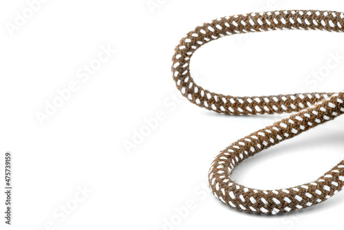 Macro photo of a brown rope with white details made of cotton and jute, isolated on a white background.