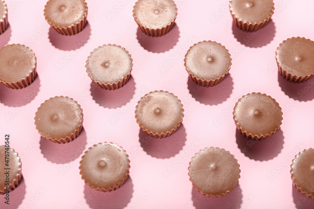 Tasty peanut butter cups on color background Tasty peanut butter cups on color background