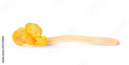 Spoon with tasty kumquat jam on white background