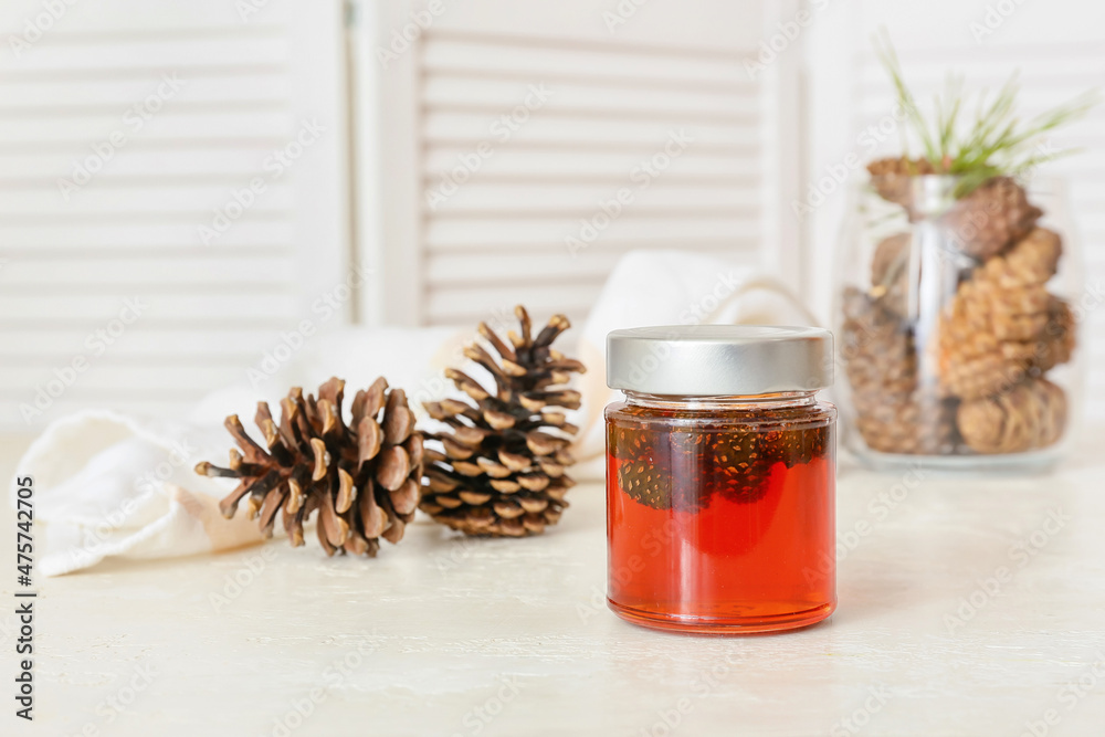 Jar of tasty pine cone jam on light table Jar of tasty pine cone jam on light table