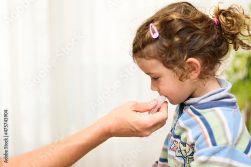 Tablou pe pânză A three-year-old girl spits into a saliva test tube for covid19 antigens