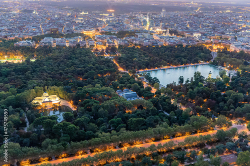 Aerial views of the city of Madrid during sunset on a clear day, being able to observe the Retiro Park, the Almudena cathedral, the Royal Palace and the Crystal Palace