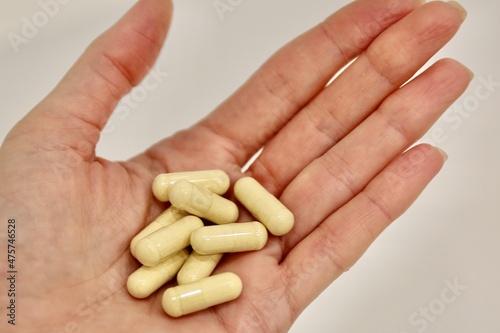 person holding a handful of pills