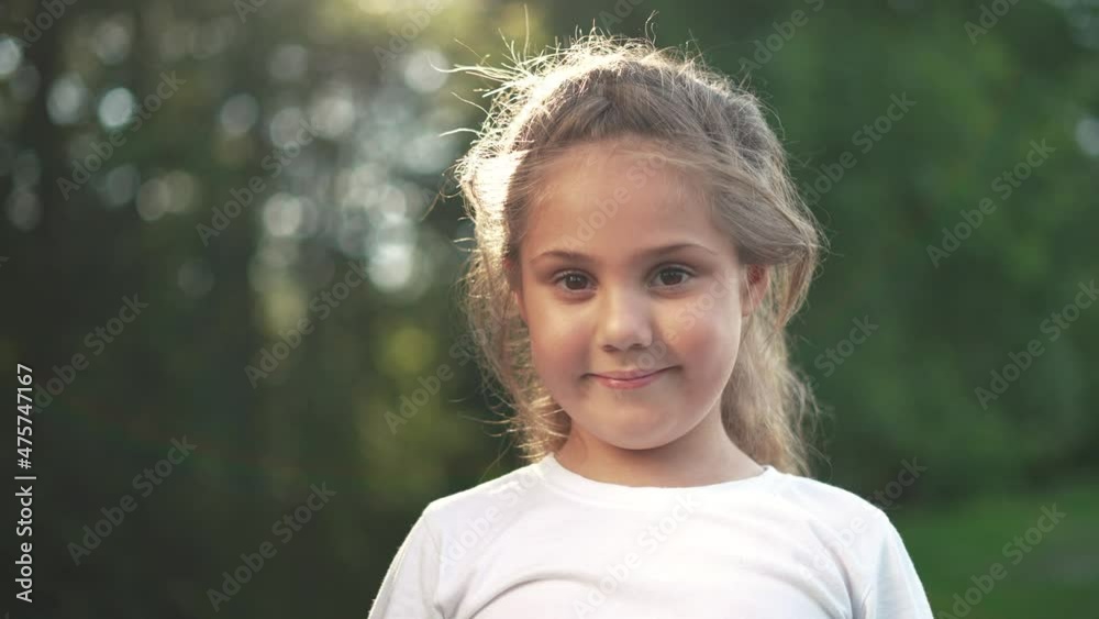 sad little girl child. a little girl is sad and lowered her head, trying to smile outdoors in the park. happy family kid dream concept. sad upset child in park outdoors. childhood family concept sun sad little girl child. a little girl is sad and lowered her head, trying to smile outdoors in the park. happy family kid dream concept. sad upset child in park outdoors. childhood family concept sun