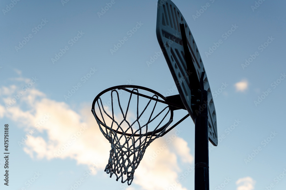 Basketball Hoop With Blue Sky In Background, Dusk