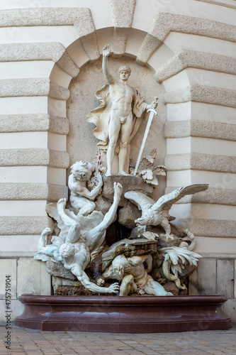 Fountain at Hofburg palace on St. Michael square (Michaelerplatz), Vienna, Austria photo