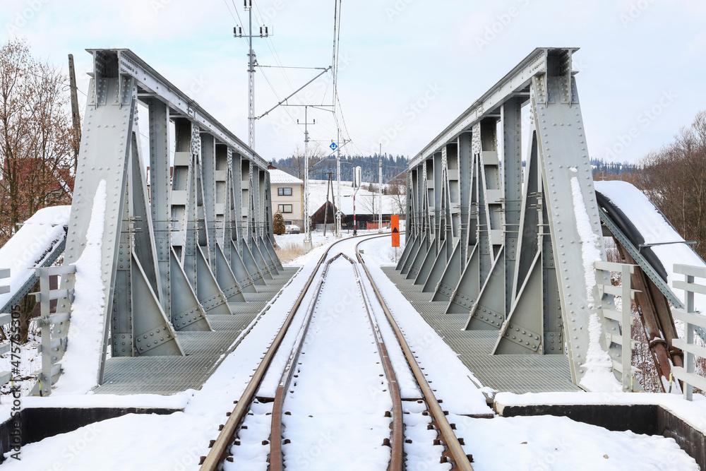 TRUTE, POLAND - NOVEMBER 30, 2021: Iron railway bridge under the snow.