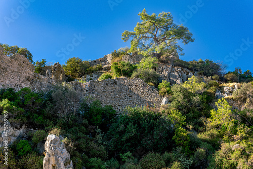 ruins of fortress walls on rocky mountain slopes near the ancient city of Olympus, Turkey
