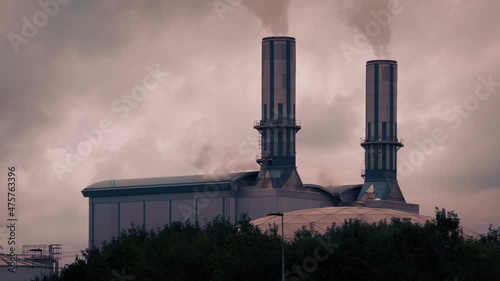 Smoking Industrial Building At Sunset
 photo