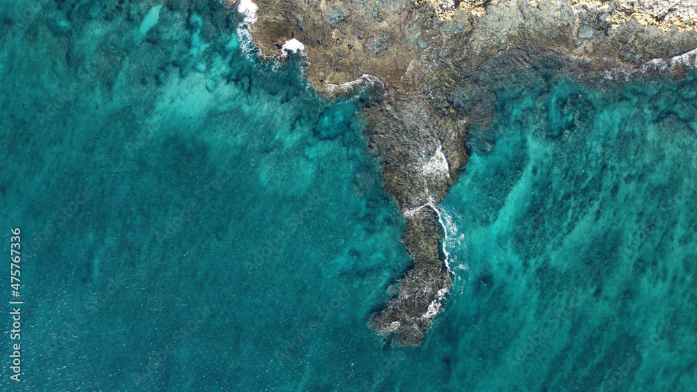 Aerial view of cliffs near a blue sea