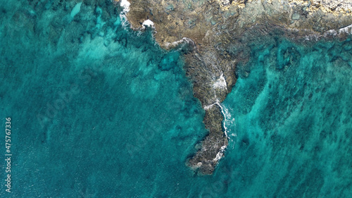 Fotografiet Aerial view of cliffs near a blue sea