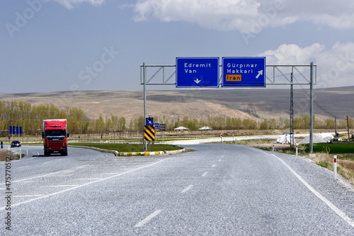 Street signs on this East Anatolian highway in Turkey give directions to the cities of Edremit, Van, Gurpinar, and Hakkari, as well as to the Turkish border with Iran