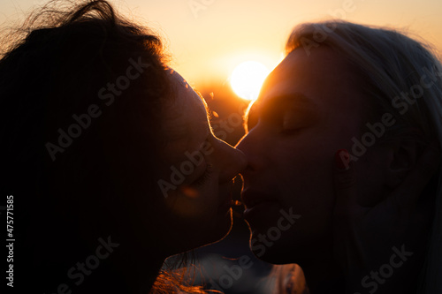 Silhouette of Romantic young couple kissing on sunset. Beginning of lovestory and relationship photo