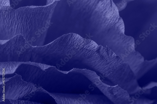Fragment of a purple flower made of crepe paper. New trending Pantone color of 2022 - Very Peri