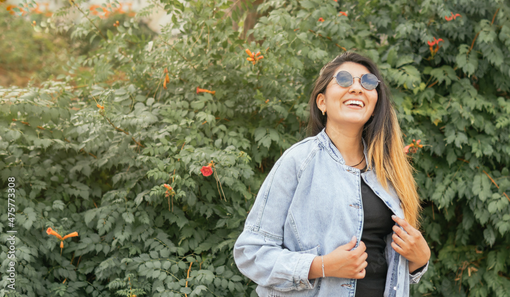A smiling latin lady with sunglasses A smiling latin lady with sunglasses