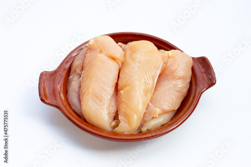 Raw chicken tenders in bowl on white background.