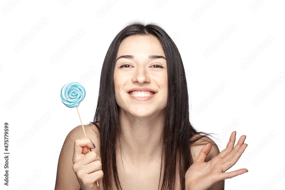 studio portrait of a beautiful brunette girl with lollipop against white backgroung. studio portrait of a beautiful brunette girl with lollipop against white backgroung.