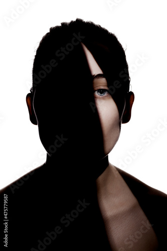 Fashionable studio portrait of a cute girl. Silhouette of a beautiful young woman with hard shadows on her face. against white backgroung