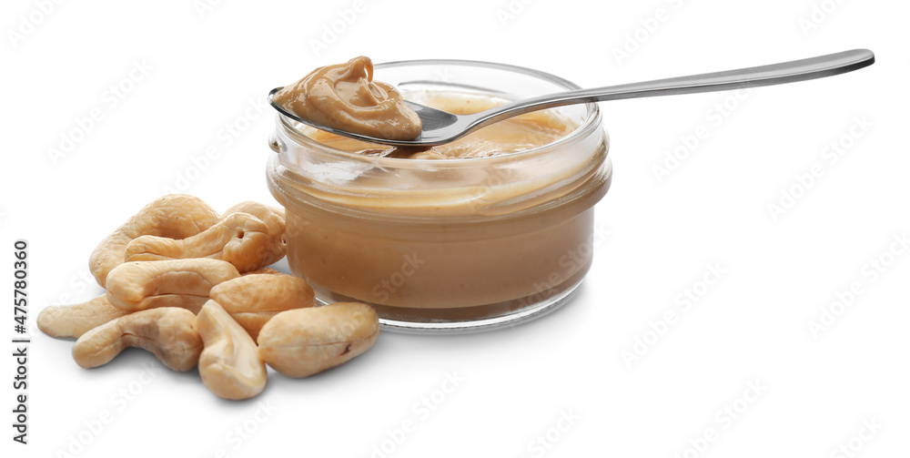 Jar and spoon with delicious cashew butter on white background Jar and spoon with delicious cashew butter on white background