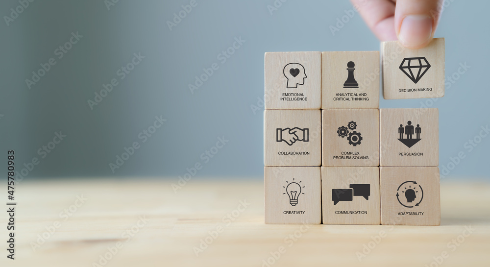 Soft skills concept. Used for presentation, banner. Hand puts wooden cubes with icons of "SOFT SKILLS" ; creativity, EQ, Problem solving, persuasion, collaboration, adaptability  on grey background. - obrazy, fototapety, plakaty 